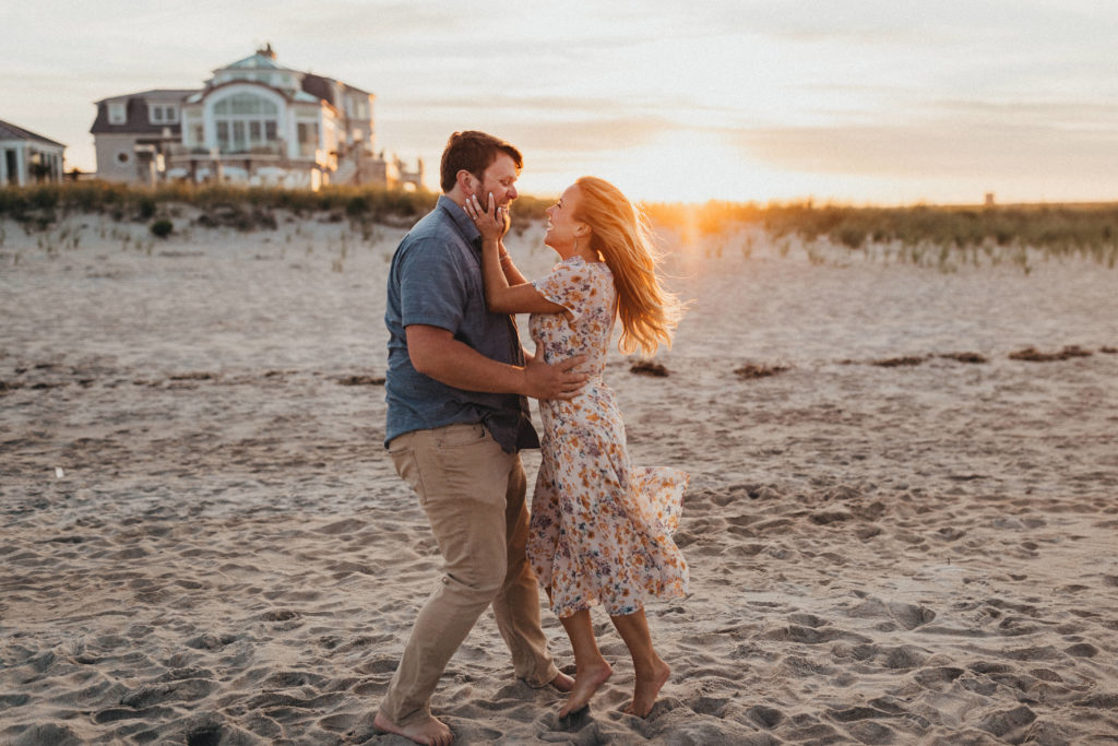 Couple wearing soft neutral colors at beach engagement session