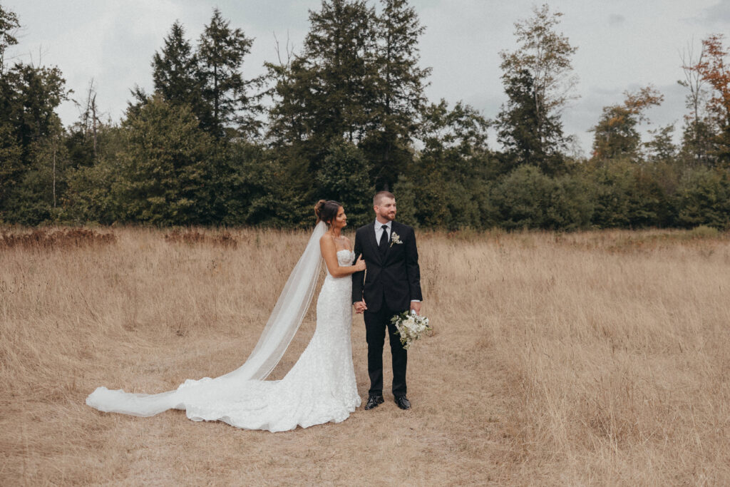 Bride and groom smiling during their portraits at the Everlee wedding venue.