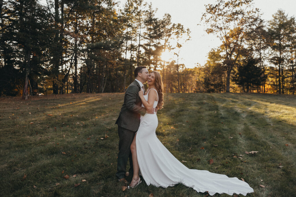 Bride and Groom smiling during golden hour portraits at their wedding in Lisbon, NH.